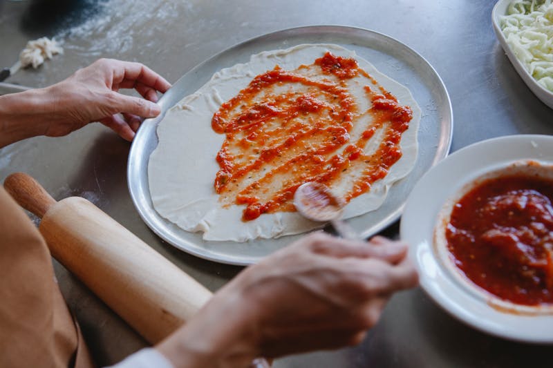 Fresh artisan pizzas being prepared for catering event